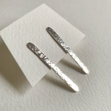 Load image into Gallery viewer, long rectangular silver stud earrings with a textured finish. Displayed on an earring card